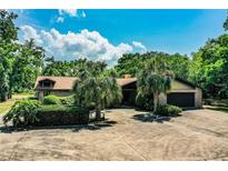 Charming single-story home with a lush yard, mature trees, and a spacious driveway at 309 Hidden Lake Dr, Brandon, FL 33511