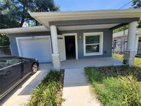 Welcoming curb appeal showcasing a freshly painted house, front yard, and covered entry at 3713 N 31St St, Tampa, FL 33610