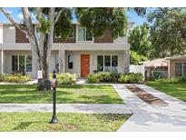 Inviting townhome featuring a well-maintained front yard and modern architectural details at 4206 W North B St # 2, Tampa, FL 33609