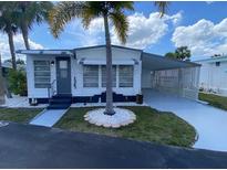 Charming single-story home with covered carport and well-maintained landscaping at 4851 W Gandy Blvd # B10L30, Tampa, FL 33611