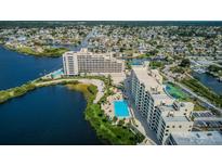 Stunning aerial view of waterfront condos with pools, sandy beach and picturesque bay views at 6009 Sea Ranch Dr # 306, Hudson, FL 34667