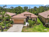 Charming single-story home with a tile roof, well-maintained landscaping, and attached garage at 137 Silver Falls Dr, Apollo Beach, FL 33572
