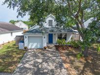 Charming single-Gathering home featuring a well-manicured front yard with a driveway leading to a one-car garage at 1421 Dew Bloom Rd, Valrico, FL 33594