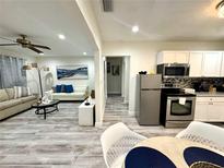 Open-concept living area features a modern kitchen, comfortable seating, and stylish decor at 1515 E Hanna Ave, Tampa, FL 33610