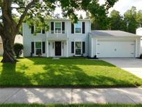 Charming two-story home with a well-manicured lawn and black shutters at 15916 Marshfield Dr, Tampa, FL 33624