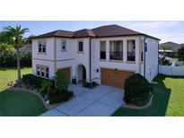 Stately two-story home with a well-manicured lawn, lush landscaping, and attached two-car garage at 1947 Marshberry Ct, Trinity, FL 34655