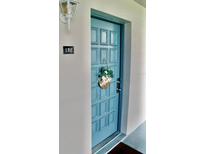 Charming unit entrance with a welcoming blue door and decorative wreath at 2737 Enterprise E Rd # 192, Clearwater, FL 33759