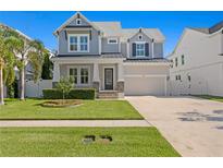 Charming two-story home features a manicured lawn and covered front porch, enhancing its curb appeal at 3605 W Dale Ave, Tampa, FL 33609
