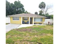 Charming single-story home with a well-maintained lawn and inviting front porch seating at 4111 W La Salle St, Tampa, FL 33607