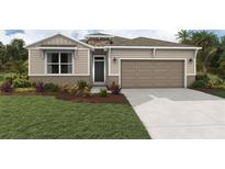 Charming single-Gathering home with a landscaped front yard and a two-car garage at 7747 Wheat Stone Dr, Zephyrhills, FL 33540