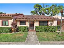 Charming single-story home with a tile roof, manicured lawn, and lush green hedges at 9737 86Th Ave, Seminole, FL 33777