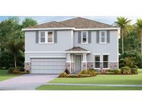 Charming two-story home featuring stone accents and a welcoming covered entry at 10457 Gentle Rain Dr, Land O Lakes, FL 34638