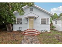 Charming single-story home with a welcoming brick walkway and light-blue painted siding at 1525 38Th N Ave, St Petersburg, FL 33704