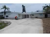 Charming single-story home features a circular driveway and well-maintained landscaping at 1897 Dolphin S Blvd, St Petersburg, FL 33707