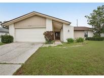 Charming single-story home with well-maintained lawn, garage, and neutral color scheme at 3121 Egret Ter, Safety Harbor, FL 34695