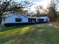 Lovely single story home with a sprawling front yard and screened lanai at 39343/39349 Rusbe, Zephyrhills, FL 33540