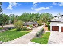 Charming one-story home featuring a well-manicured lawn and long concrete driveway at 4640 W Lamb Ave, Tampa, FL 33629