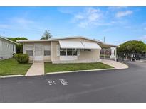 Charming single-story home featuring a covered carport and well-maintained landscaping at 7118 El Meyers St, Zephyrhills, FL 33541