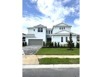 Beautiful two-story home with a manicured lawn and a two-car garage with a brick paved driveway at 8316 Golden Beach Ct, Parrish, FL 34219