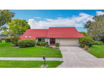 Charming single-story home with well-manicured lawn and a red tiled roof, perfect for curb appeal at 8822 Misty Creek Dr, Sarasota, FL 34241
