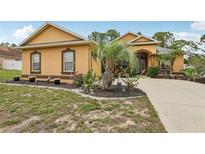 Charming single-Gathering home with stucco siding, tasteful landscaping, and a cozy, welcoming front yard at 14494 Copeland Way, Brooksville, FL 34604