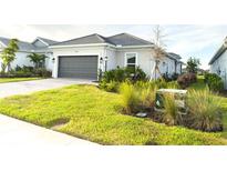 Beautiful single-Gathering home with an attached garage and well-manicured lawn at 16126 San Donato Pl, Bradenton, FL 34211