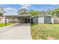 Charming single-story home with a covered carport and well-maintained lawn at 2526 W Jean St, Tampa, FL 33614