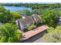 An exterior view of the condos, with a view of the lake and covered parking at 5122 Puritan Cir # 5122, Tampa, FL 33617