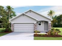Charming single-story home featuring stone accents, a gray facade, and well-manicured landscaping at 6851 Broad River Ave, Land O Lakes, FL 34638