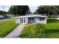 Charming, single-story home boasts a freshly painted exterior, well-manicured lawn, and inviting curb appeal at 8502 Grapefruit Ave, Tampa, FL 33619