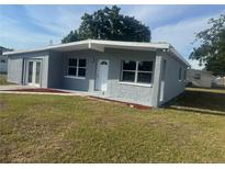 Charming gray home with white trim, well-kept lawn, and inviting front entrance at 8502 Grapefruit Ave, Tampa, FL 33619