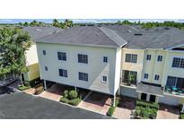 Charming townhome with carports and well-maintained landscaping, showcasing its inviting curb appeal at 9731 Meadow Field Cir, Tampa, FL 33626