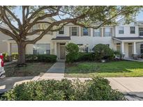 Charming two-story townhouse featuring manicured landscaping and inviting front entrance at 13521 Forest Lake Dr, Largo, FL 33771