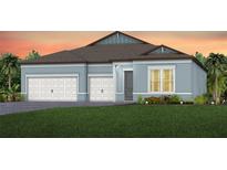 Charming single-story home with a three-car garage, well-manicured lawn, and beautiful landscaping at 1576 Valier Pt, Zephyrhills, FL 33541