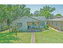 Charming single-story home with a well-manicured lawn and inviting blue door at 1620 15Th N St, St Petersburg, FL 33704