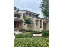 Charming two-story home featuring manicured landscaping and a welcoming front entrance with a red door at 2332 S Fairway Dr, Plant City, FL 33566