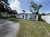 Charming single-story home with a unique teal door, awaiting your personal touch at 2524 Novus St, Sarasota, FL 34237