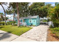 Charming bungalow featuring a well manicured lawn, brick driveway and quaint front porch at 2709 Upton S St, Gulfport, FL 33711