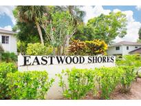 Eastwood Shores sign surrounded by colorful shrubbery, establishing the community's name and location at 2943 Bough Ave # C, Clearwater, FL 33760