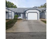 Charming single-story home featuring a one-car garage and well-maintained landscaping at 39650 Us Hwy 19 N, Tarpon Springs, FL 34689