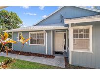 Charming single story home with a well-manicured lawn and inviting front door at 4418 Pine Meadow Ct, Tampa, FL 33624