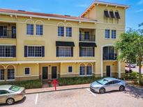 Attractive three-story building with balconies, black shutters and awnings, and lush landscaping at 119 Beach Haven Ln, Tampa, FL 33609