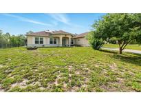Charming single-story home featuring a well-maintained lawn and inviting curb appeal at 15348 Glossy Ibis Rd, Weeki Wachee, FL 34614