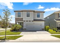Charming two-story home featuring stone accents, neutral siding, paver driveway and a two-car garage at 4679 Emprise Way, Land O Lakes, FL 34638