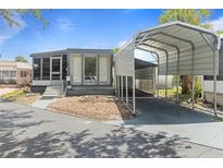 Charming single-story home featuring a covered carport and a cozy screened-in porch at 4851 W Gandy Blvd # B1L8, Tampa, FL 33611