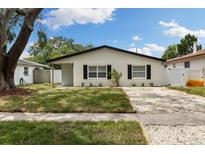 Charming single-story home featuring a well-manicured lawn and gravel driveway at 621 89Th N Ave, St Petersburg, FL 33702