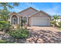 Charming single-story home featuring a well-manicured lawn and an attached two-car garage at 1135 Millbrook Cir, Bradenton, FL 34212