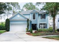 Charming two-story blue home with a well-manicured lawn and inviting front entrance at 17734 Long Ridge Rd, Tampa, FL 33647