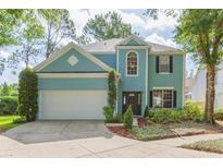 Charming two-story home featuring a well-manicured lawn, a two-car garage, and a welcoming entrance at 17734 Long Ridge Rd, Tampa, FL 33647