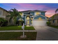 Charming two-story home with well-manicured lawn and lush landscaping at 25521 Bruford Blvd, Land O Lakes, FL 34639